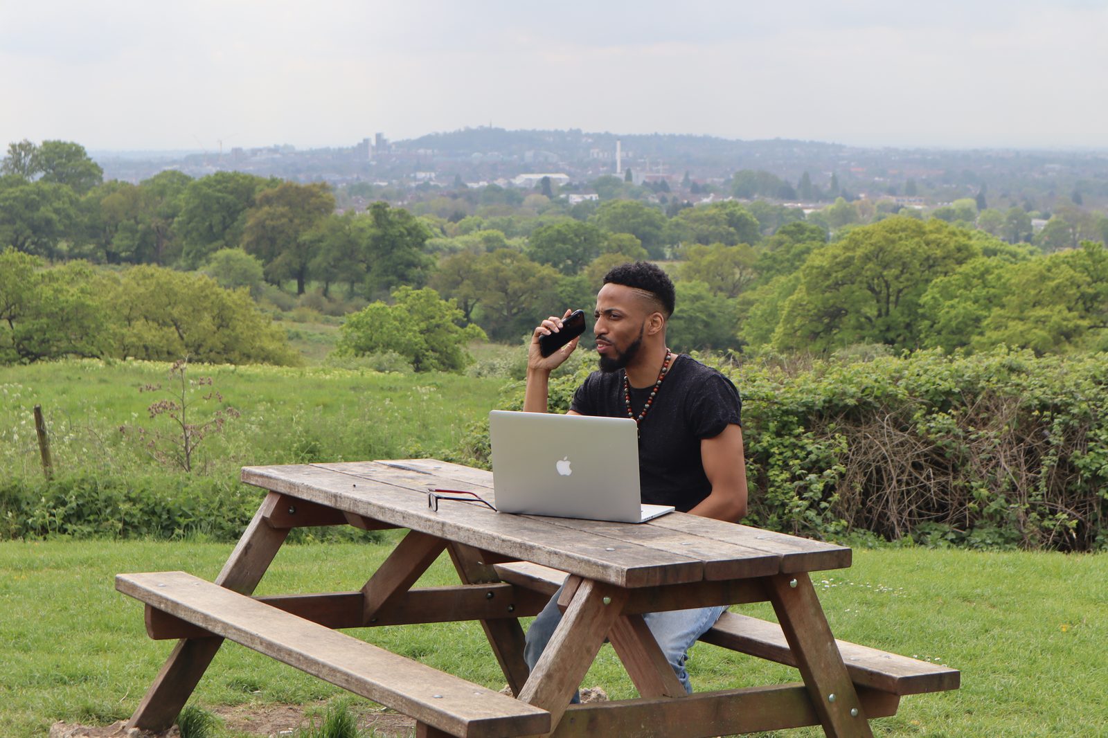 LiberatingU working outdoors with city landscape - entrepreneur and coach building his vision
