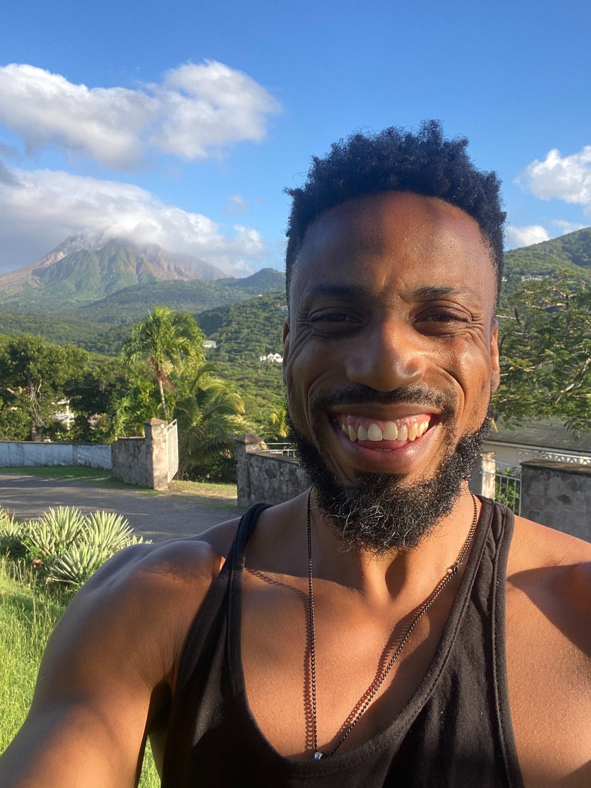 LiberatingU smiling with tropical mountain backdrop - entrepreneur and online marketing coach